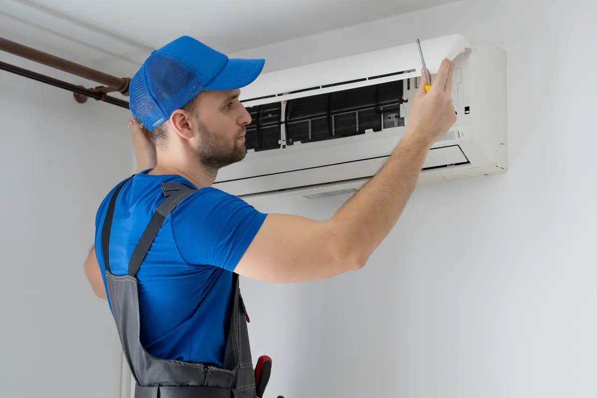AC Fails First Hot Day San Bruno CA — technician restarting an AC system for summer