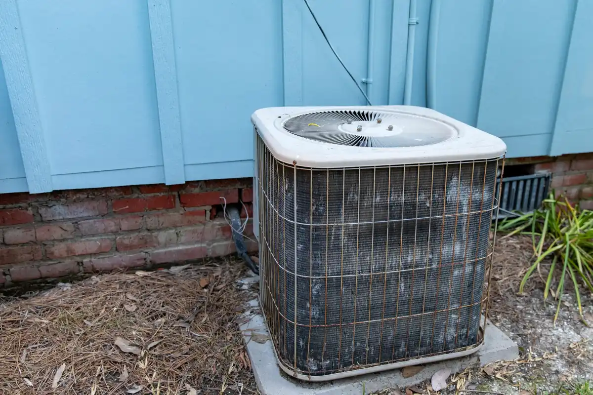 How Long Does Central AC Last San Bruno CA — older outdoor AC unit at a home