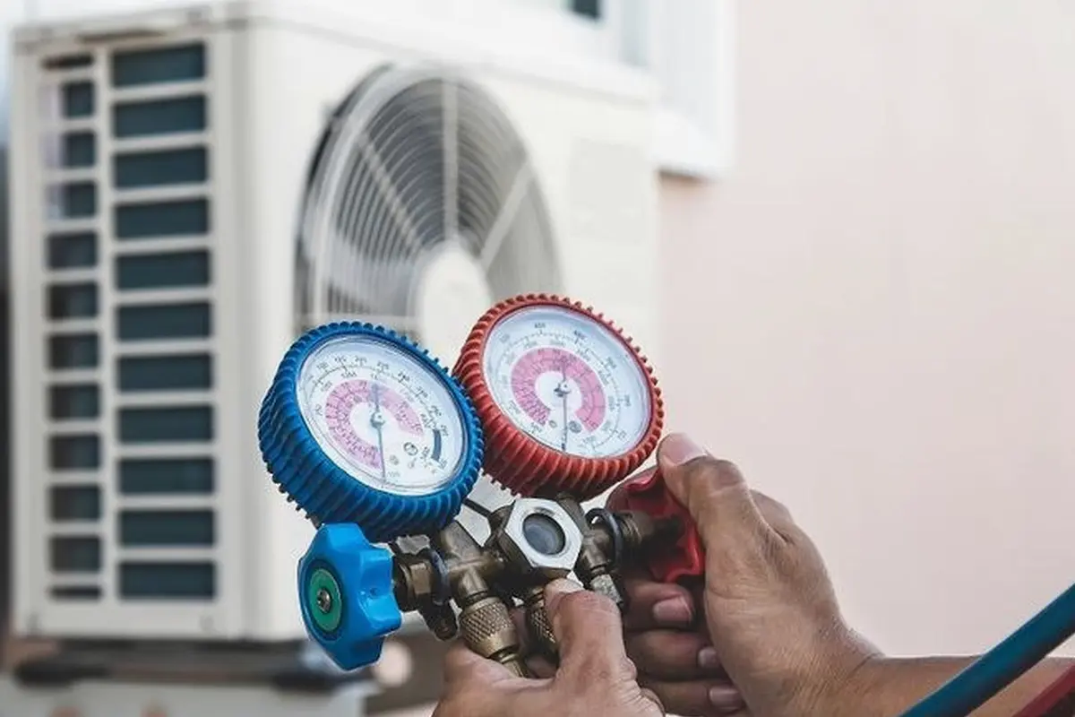 Frozen Evaporator Coil Repair in Mills Park San Bruno CA — refrigerant gauges during AC service