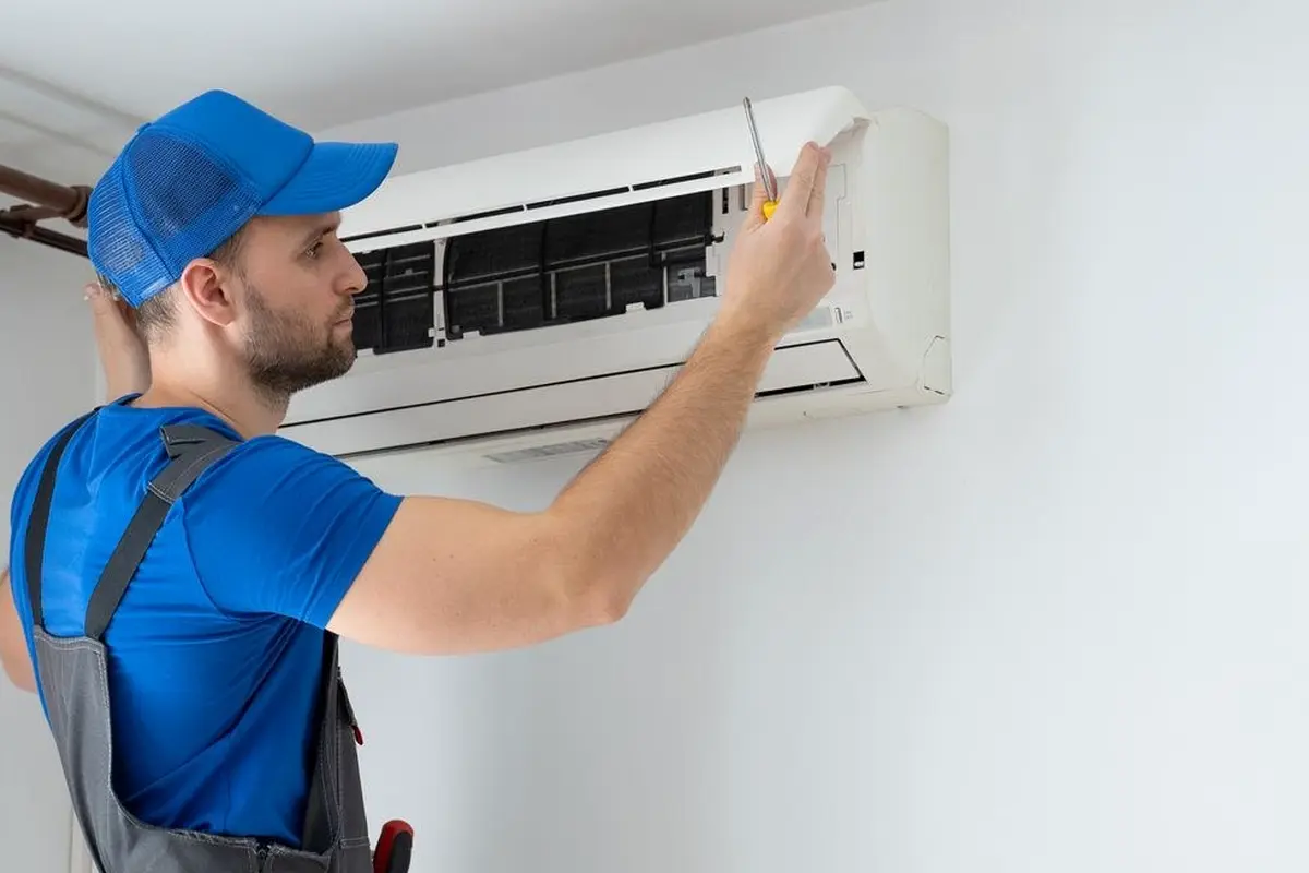Central AC Repair San Bruno CA — AC technician servicing an outdoor condenser unit